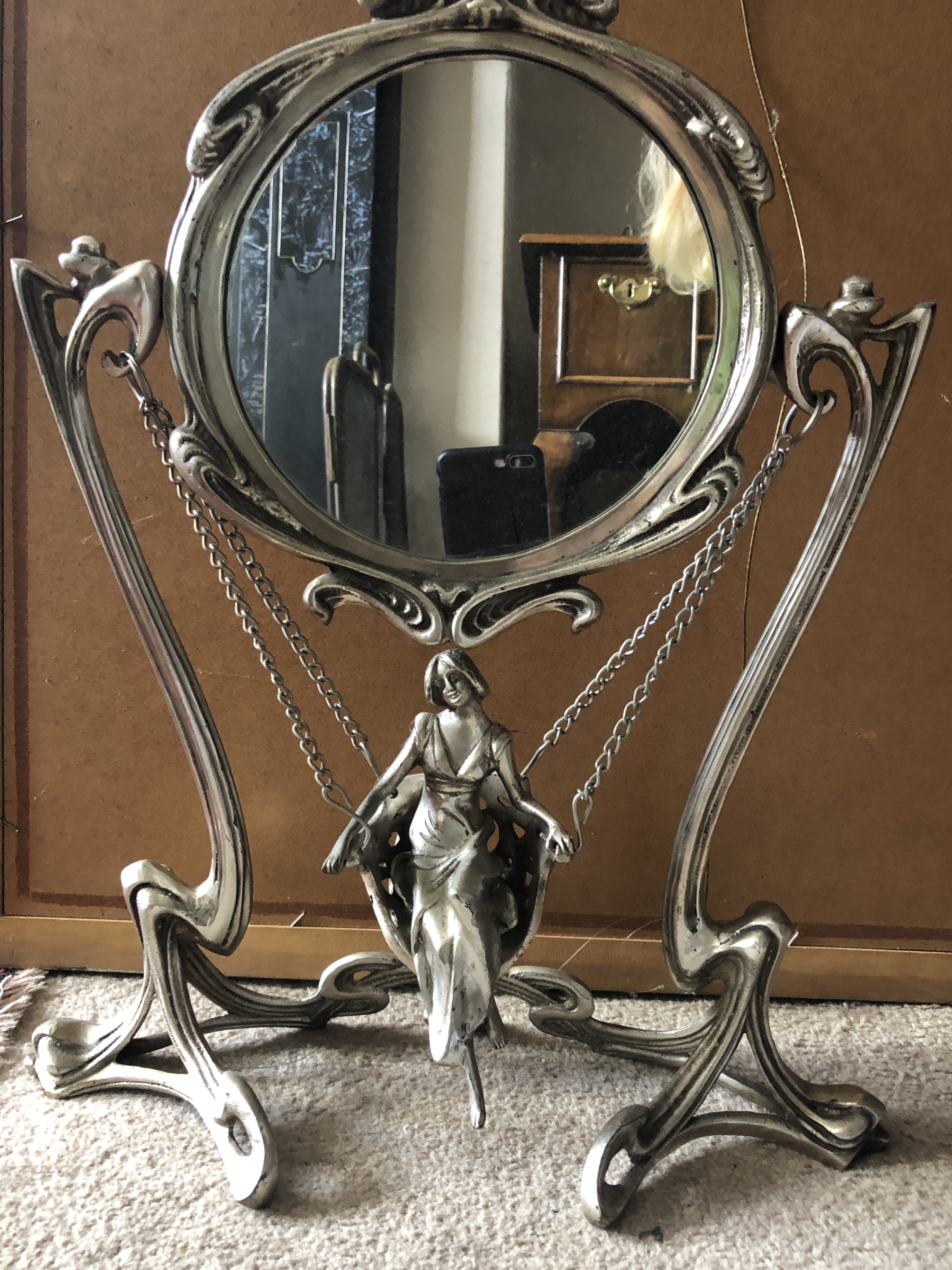 A French Art Art Nouveau style mirror with lady in swing to base. 46cms h.