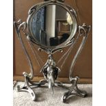 A French Art Art Nouveau style mirror with lady in swing to base. 46cms h.