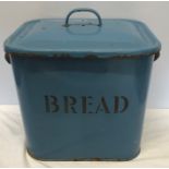 A blue enamelled metal bread bin.