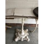 A 19thC cast iron table with granite top.