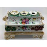 A 19thC porcelain inkstand with floral and gilt decoration and lion masks, 2 inkwells and a pounce