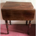 A work table, two drawers to one side, dummy drawers to the other on brass castors with drop leaves.