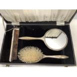 A boxed silver backed mirror, brush and comb, comb a/f, engine turned decoration, Birmingham 1973.