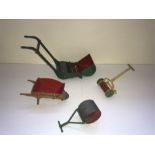 Four Dinky playworn metal gardening implement toys comprising a Dinky Toys wheelbarrow, a Meccano