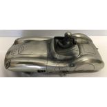 A polished solid pewter model of an Aston martin. 32cms l.
