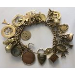 A 9 carat gold charm bracelet with approximately 30 charms in 9 ct and above. 128gms total.