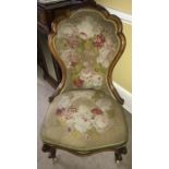 A walnut framed spoon backed Victorian chair in original woolwork embroidery.
