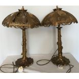 Pair of decorative brass table lamps. Tree stump and vine design base, missing 2 hessian panels on