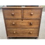 A Victorian mahogany chest of drawers on bun feet. 2 over 2. 99 h x 102 w x 47cms d.