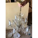 A 5 branch glass drop and gilt chandelier, drop height 84cms, Width 50cms.