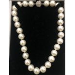 A boxed contempory simulated pearl necklace.