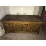 An oak blanket box with carving to panelled front. 121 w x 47 d x 52cms h.