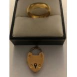 An 18 carat gold wedding ring with a 15 carat gold padlock. 3.7gms each.