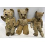 Three well loved plush fur teddy bears, worn fur, damaged limbs, stitching. 36cms h largest.