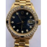 A lady's 18 carat gold Rolex, Oyster Perpetual Datejust wristwatch with diamonds and sapphires to