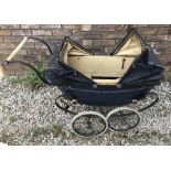 A vintage Pedigree twin hooded pram.