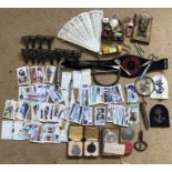 Mixed lot of small collectables. Wills cigarette cards, Postman armband, Ivorine fan, brass desk