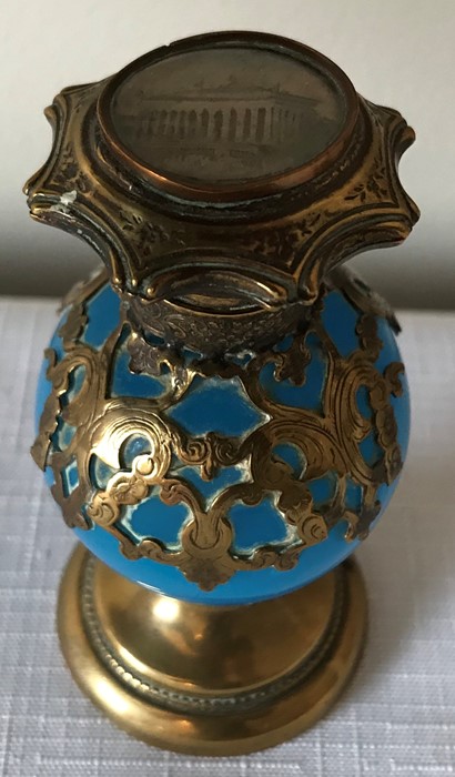 A 19thC turquoise glass and brass encased scent bottle. 9.5cms h with painted classical building