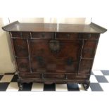 Oriental cabinet with metal fittings. 98 w x 35 d x 77cms h.