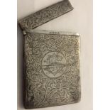 A silver card case with foliate scroll engraving and monogram to front, 10 x 7cms Birmingham 1907.
