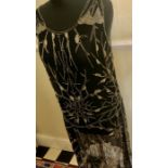 A 1920's black silk chiffon beaded dress in good condition with a few loose beads to front.