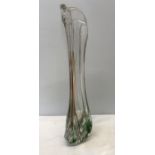 A tall studio glass vase, clear with green and brown streaks, signed to base Max Verboeket.