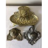 Three vintage brass and metal inkwells in Art nouveau designs.