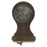 A mahogany inlaid chiming mantle clock. 34cms h.