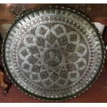 A white metal and copper engraved circular tray/table top. 70cms d.