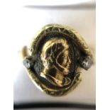 A gentlemans 2 tone yellow metal and diamond ring, tested as 14ct, a centurions head flanked by 2