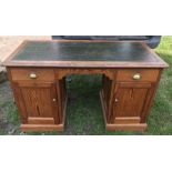 A Victorian pitch pine double sided pedestal teachers desk with leather insert top. Ex Woodmansey