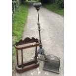 Victorian brass and cast iron standard oil lamp and a brass magazine rack, unpolished, together with