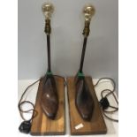 A pair of vintage wooden shoe lasts converted for use as table lamps.