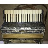 A Hohner piano accordion finished in faux blue mother of pearl.