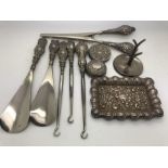 Hallmarked silver ring stand, pin tray, silver handled button hooks, glove stretchers, shoe horn