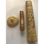 An ivory perpetual calendar, needlecase, 7.5cms and a carved Chinese bone knife holder/handle.