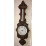 Oak cased aneroid barometer. 95cms h.