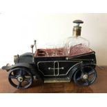 A vintage musical decanter modelled as a vintage car with 2 shot glasses, missing 4.