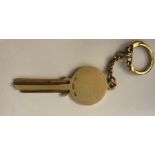 A 9 carat gold key keyring inscribed to front. 15.1gms.