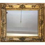 A gilt frame mirror. Frame size 87 h x 99cms w. Mirror 61 h x 73cms w.