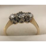 A three stone diamond ring in 18 carat gold. Size n. 1.9gms.