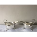 A pair of hallmarked silver sauce boats James Dixon and Sons, Sheffield 1935 with sugar tongs,