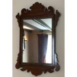 A 19thC mahogany fretted wall mirror.