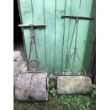 A vintage cast iron York Cast garden roller with another iron and concrete roller.