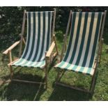Two vintage wooden framed deck chairs, one with arms, with striped canvas seats in good order.