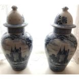 A pair of 19thC Delft blue/white lidded vases. 35cms h.