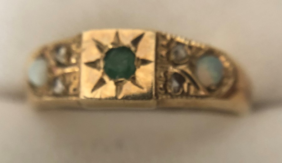 A 9 ct gold ring set with opals, diamonds and emerald. Size O. 2gms. - Image 2 of 4