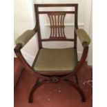 A 19thC mahogany armchair with cross stretcher base, upholstered arms and seat.