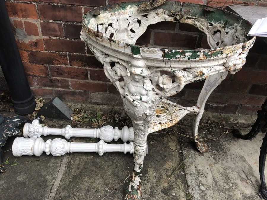 A 19thC cast iron table base and 2 cast iron pillars. 58 d x 73cms h.