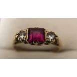 A 9 ct gold ring with central pink stone flanked by 2 diamonds. Size N. 2.3gms.